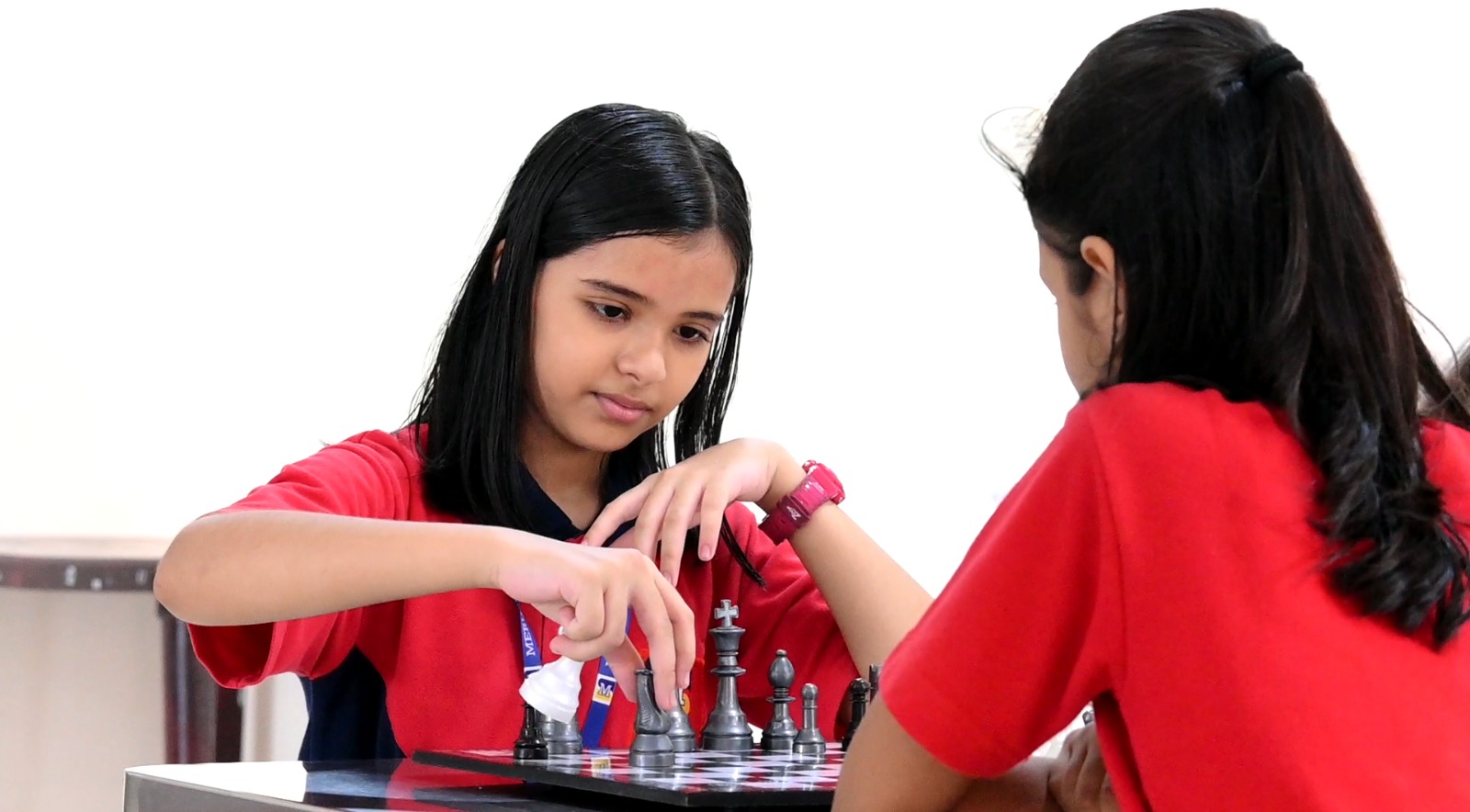 Meru International School students making calculated moves in a chess match.